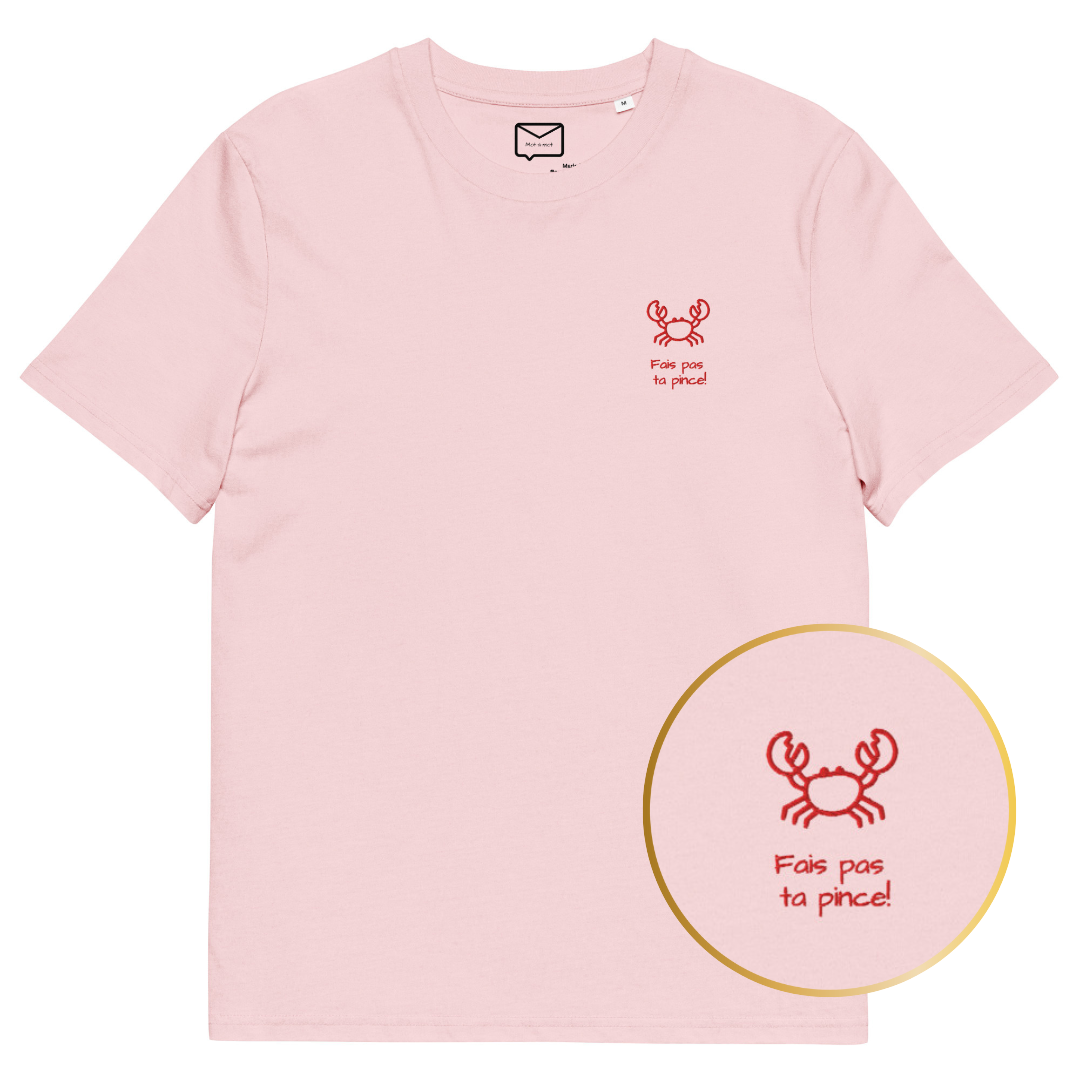 Front view of a light pink short-sleeved t-shirt featuring a small, illustrated red crab and the humorous French phrase "Fais pas ta pince!" (Don't be stingy!) in a simple red font beneath it, located on the left side of the chest.