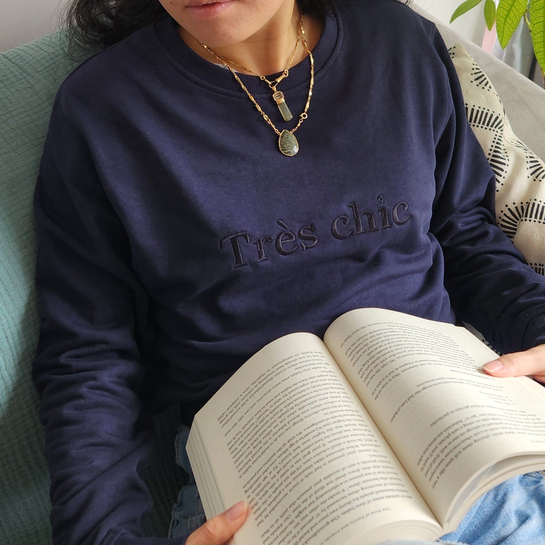 Dark blue sweatshirt with the French phrase "Très Chic" (Very Chic) embroidered in darker blue lettering on the chest