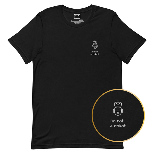 Front view of a black short-sleeved t-shirt featuring a small, line-art style illustration of a robot and the phrase "I'm not a robot" in a simple white font beneath it, located on the left side of the chest.