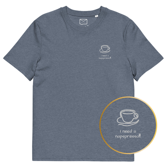 Front view of a greyish blue short-sleeved t-shirt featuring a small, line-art style illustration of a coffee cup on a saucer, with the humorous phrase "I need a napspresso!!" in a playful font beneath it, located on the left side of the chest