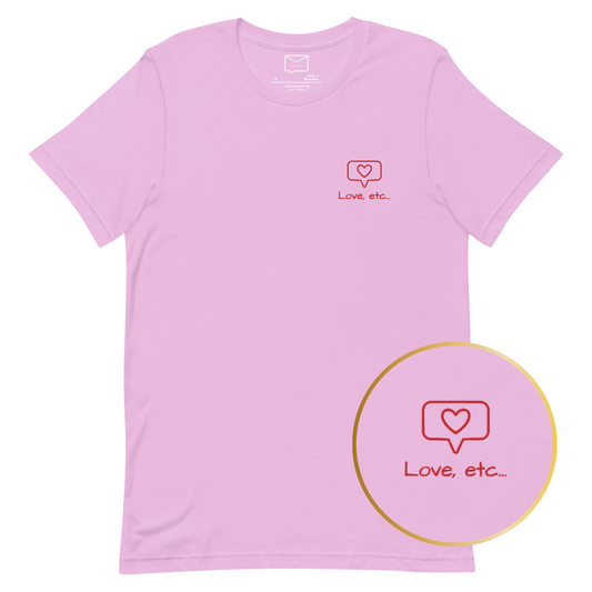 Front view of a light pink short-sleeved t-shirt featuring a small, outlined red heart inside a speech bubble, with the text "Love, etc..." in a simple red font beneath it, located on the left side of the chest