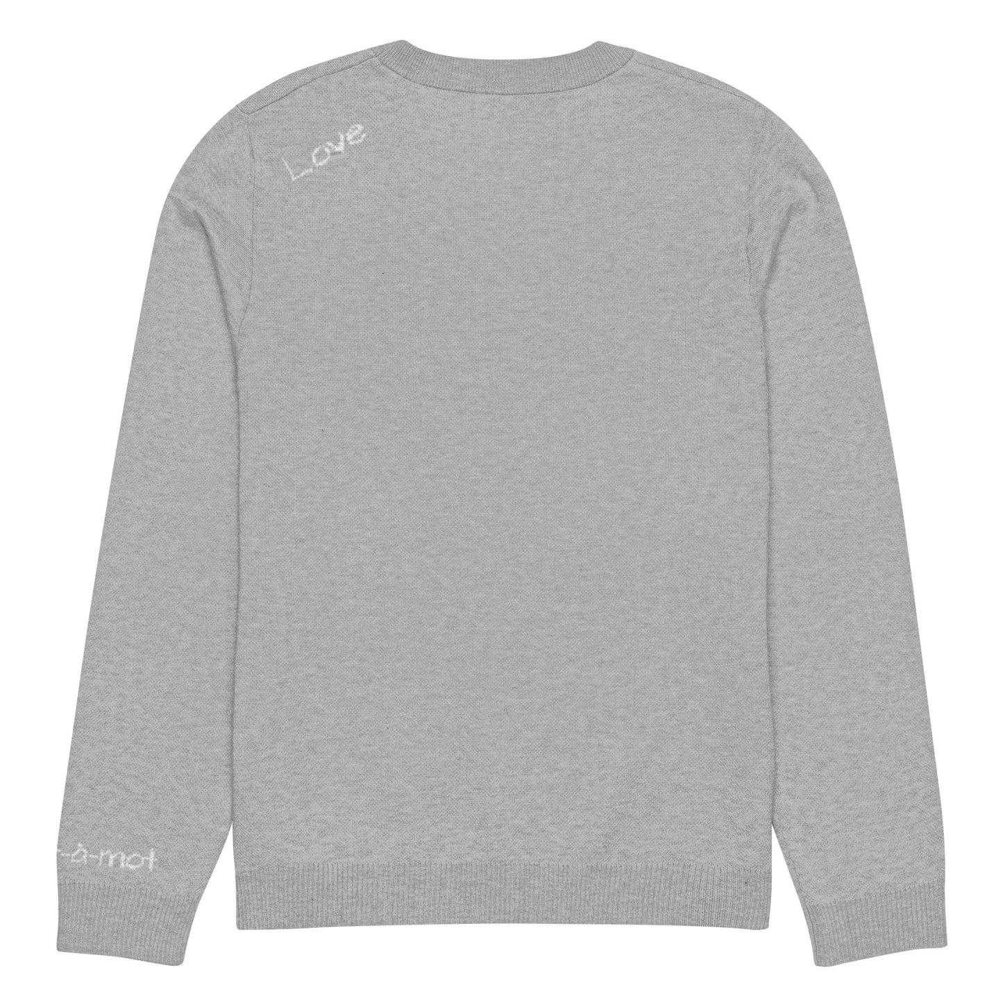 Back view of a grey knitted jumper with a ribbed neckline, cuffs, and hem. The word "Love" is written in white on the upper back. A small embroidered brand tag "mot-à-mot" is visible on the lower right sleeve