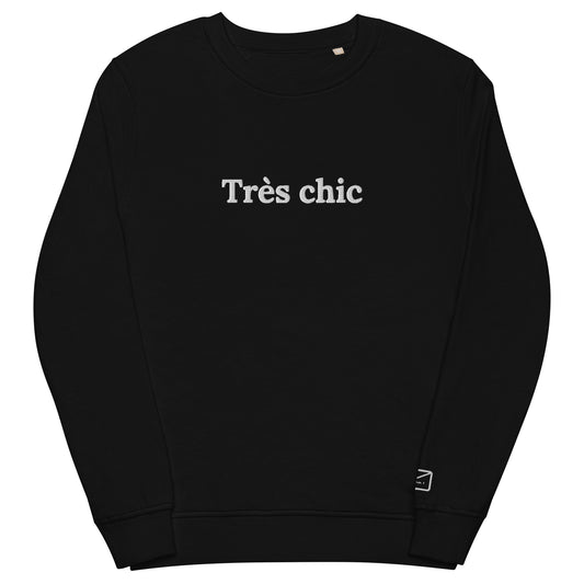 Black crew neck sweatshirt featuring the embroidered phrase "Très Chic" (very chich) in white lettering across the chest.